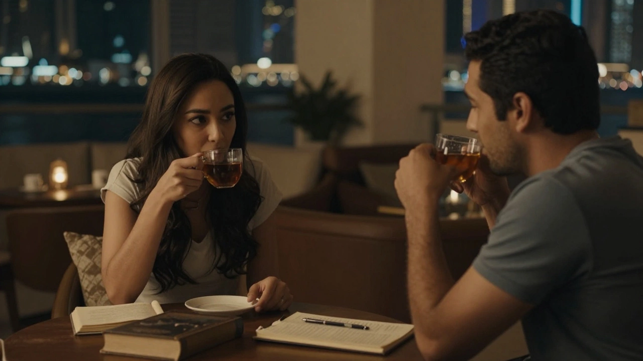 Two people sitting in silent conversation in a cozy lounge, sharing tea and presence.